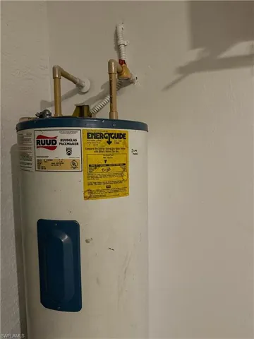 Detailed view of electric water heater and a textured wall