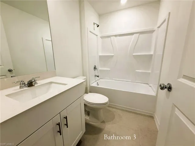 Full bathroom featuring vanity, tub / shower combination, and light tile patterned floors