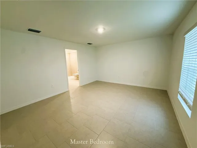 Spare room featuring baseboards