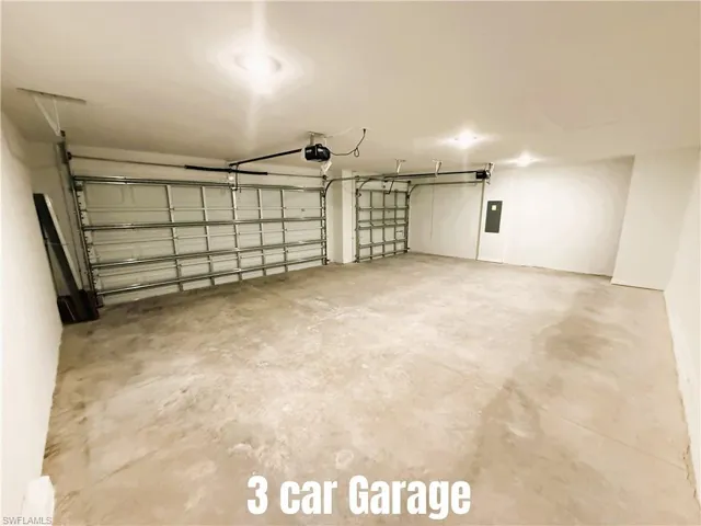 Garage with electric panel and a garage door opener