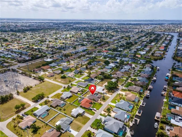 Birds eye view of property with a water view and a residential view