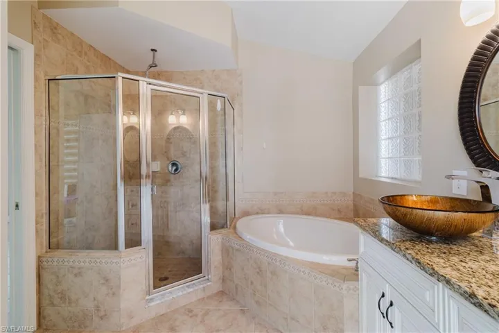 Full bath with a bath, a stall shower, vanity, and tile patterned flooring