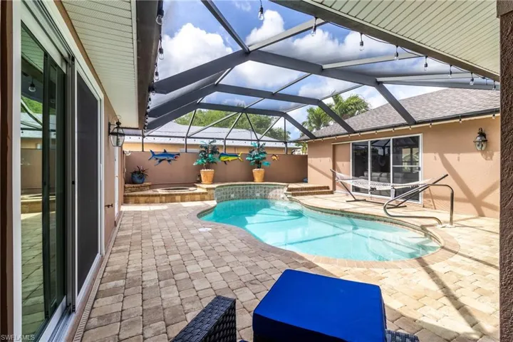 Outdoor pool featuring a patio and an in ground hot tub
