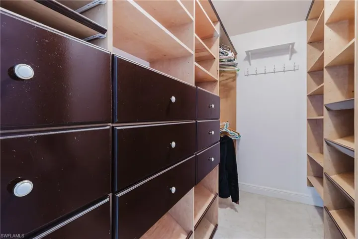 Spacious closet with light tile patterned floors