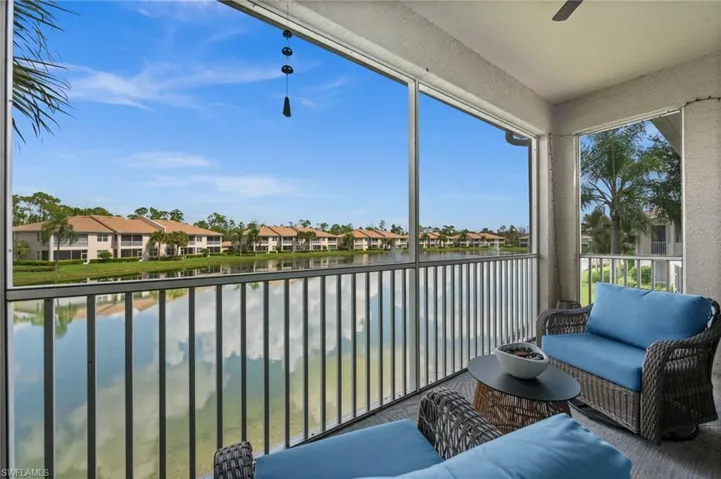 Screened balcony with textured walls and a ceiling fan