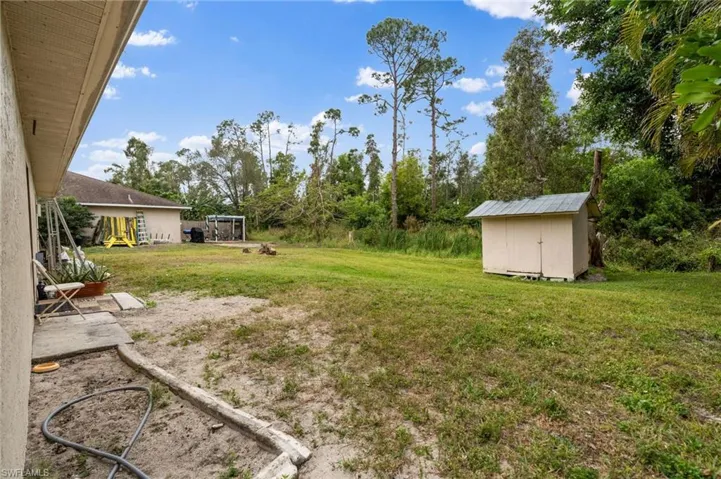 View of yard with a storage unit