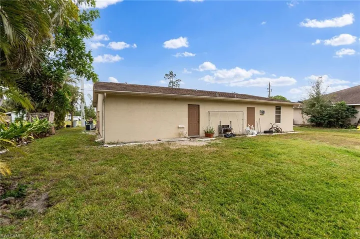 Back of house featuring a lawn