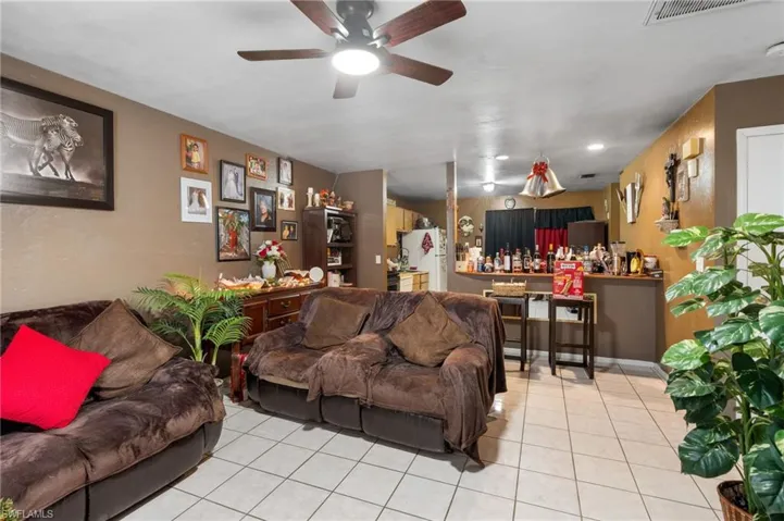 Tiled living room featuring ceiling fan