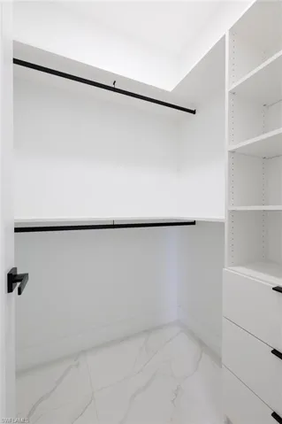Spacious closet featuring light tile patterned floors