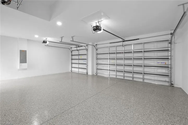 Garage with electric panel and a garage door opener