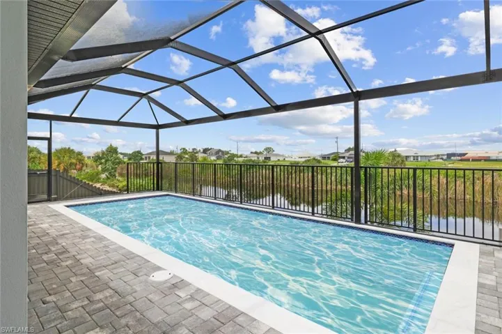 View of swimming pool with a patio and a lanai