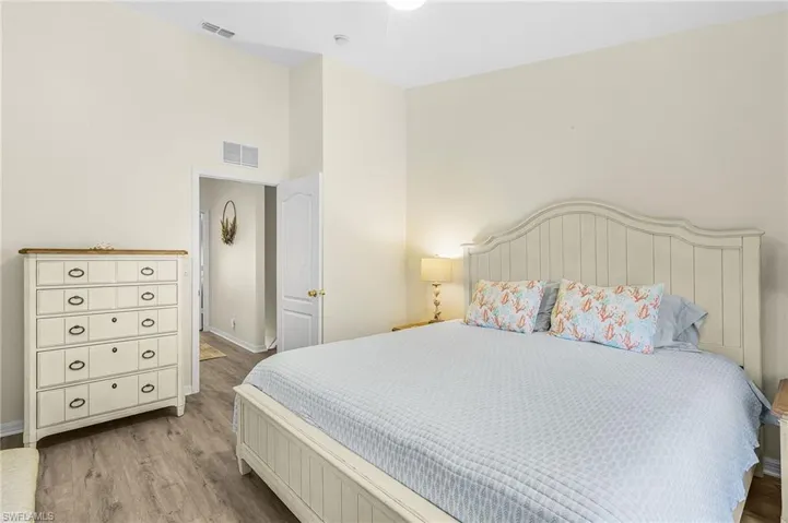 Vaulted ceilings, wood-finish flooring, and a solid core interior door