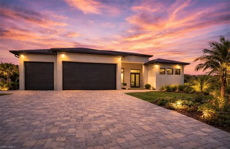 Prairie-style home featuring a garage, stucco siding, and driveway (Rendered photo)