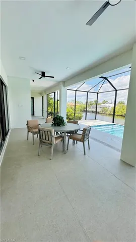 Expansive screened lanai featuring a swimming pool, waterfront access, and recessed lighting