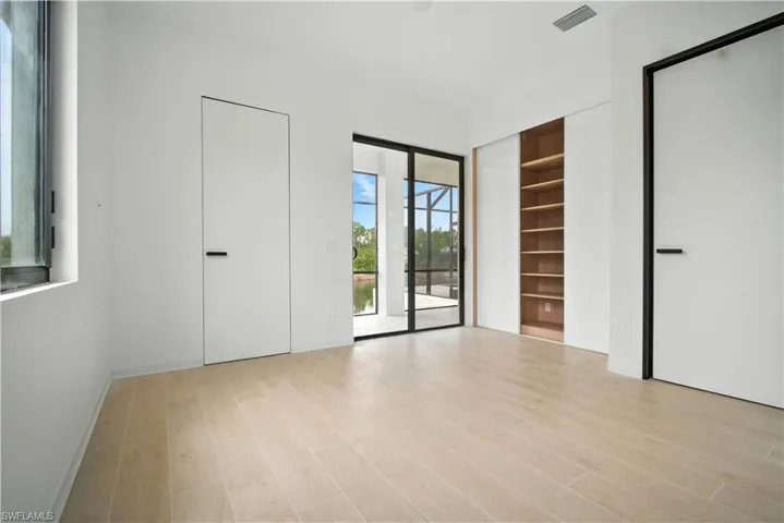 Unfurnished bedroom featuring access to outside and light wood finished floors