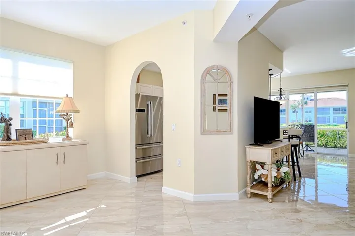 Living room with light porcelain flooring and arched walkways