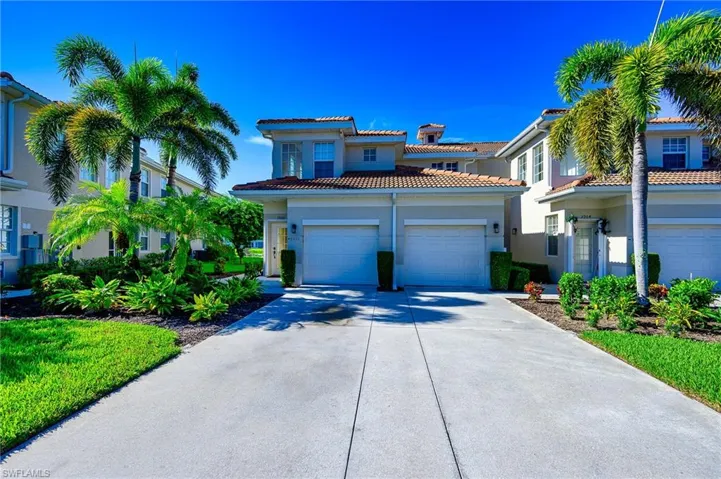 Mediterranean / spanish home featuring driveway, an attached garage, stucco siding, and a tiled roof