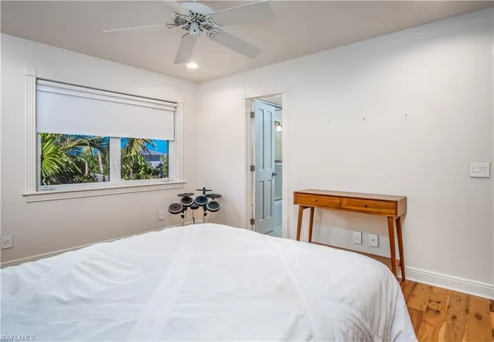 Bedroom with ceiling fan and hardwood / wood-style floors