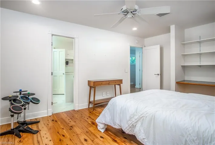Bedroom featuring hardwood / wood-style flooring and ceiling fan