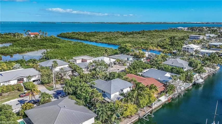 Birds eye view of property with a water view