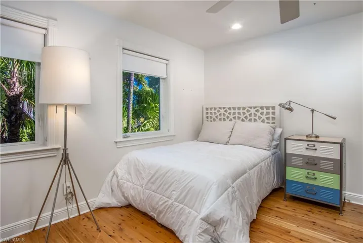 Bedroom featuring ceiling fan and hardwood / wood-style floors