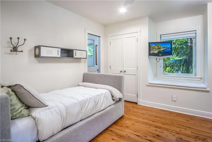 Bedroom with a closet and light hardwood / wood-style floors