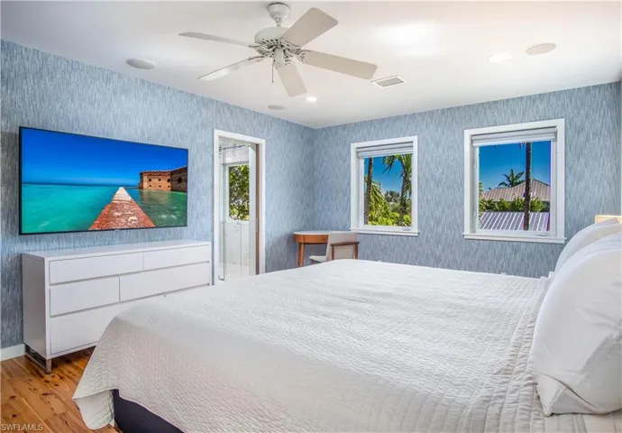 Bedroom with ceiling fan and light wood-type flooring