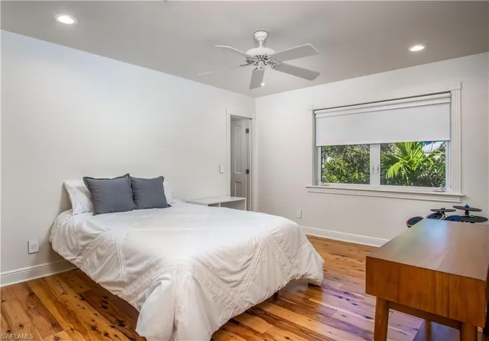 Bedroom featuring ceiling fan and hardwood / wood-style floors