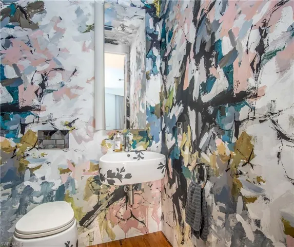 Bathroom featuring sink, hardwood / wood-style floors, and toilet