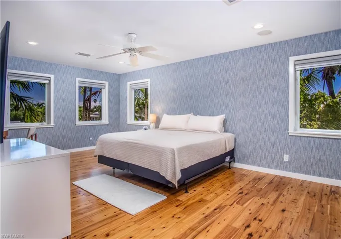 Bedroom featuring ceiling fan and light hardwood / wood-style floors