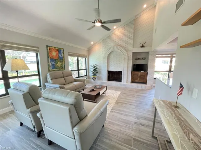 featuring a fireplace, vaulted ceiling