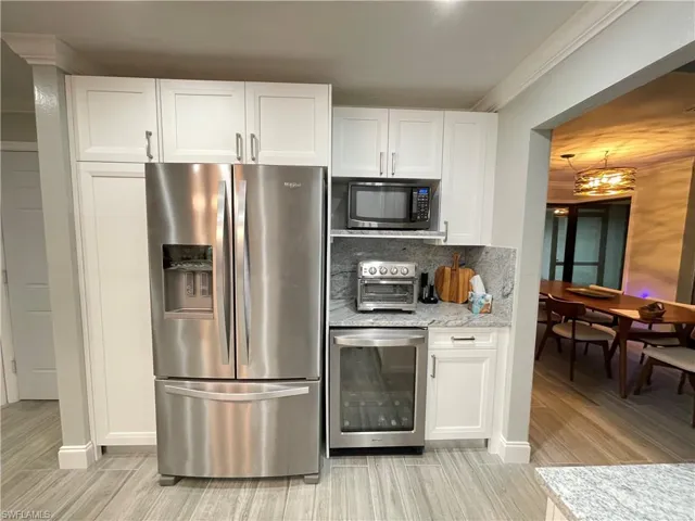 Kitchen featuring Beverage cooler, and appliances with stainless steel finishes
