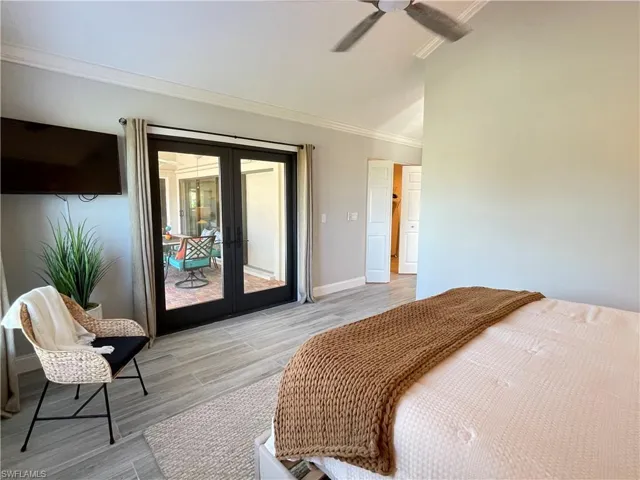 Bedroom featuring french doors, ornamental molding, ceiling fan, and access to exterior