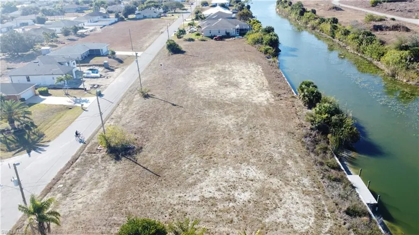 Aerial perspective of suburban area featuring a large body of water