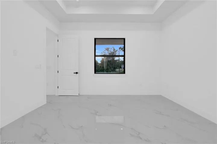 Unfurnished room featuring a raised ceiling