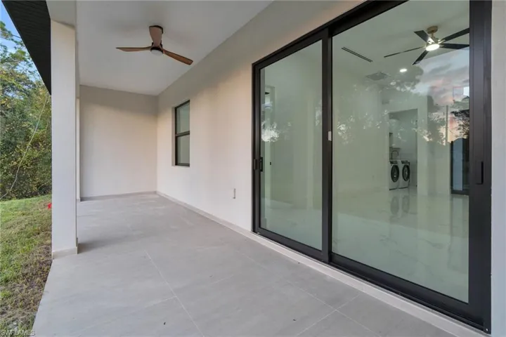 View of patio featuring a ceiling fan and separate washer and dryer