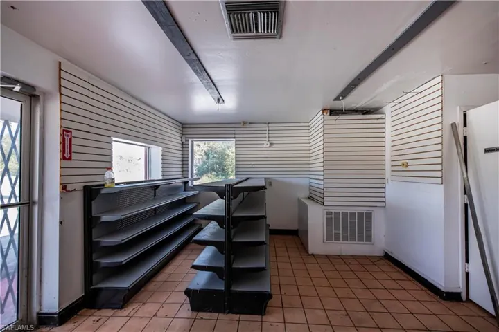 Miscellaneous room with light tile patterned floors, visible vents, and baseboards