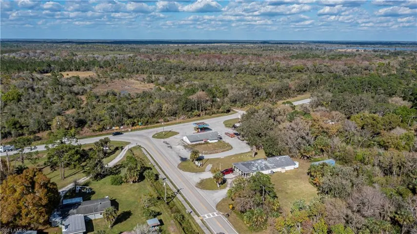 Birds eye view of property featuring a wooded view