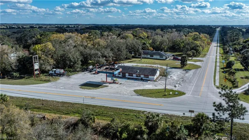 Birds eye view of property with a view of trees