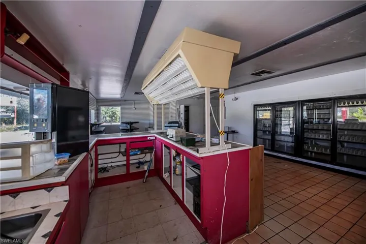 Kitchen with red cabinetry and visible vents