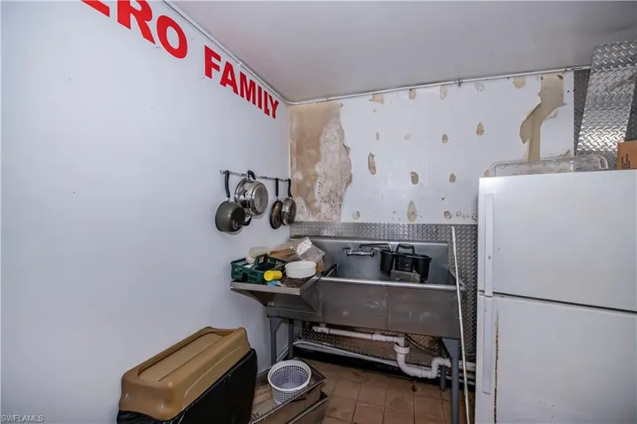 Kitchen with freestanding refrigerator and tile patterned floors