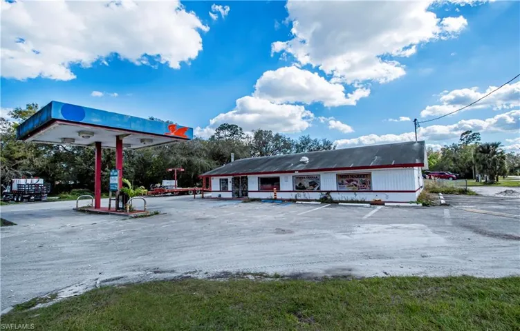 View of property with uncovered parking