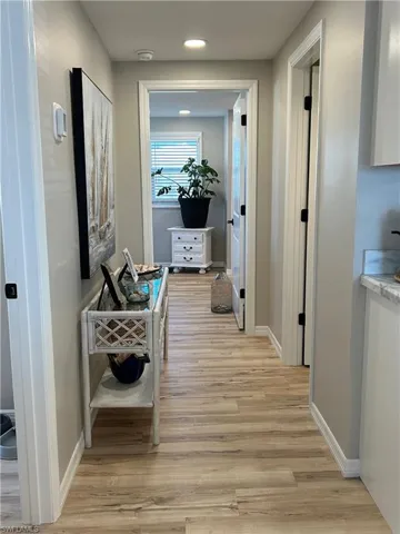 Hallway with light hardwood / wood-style floors