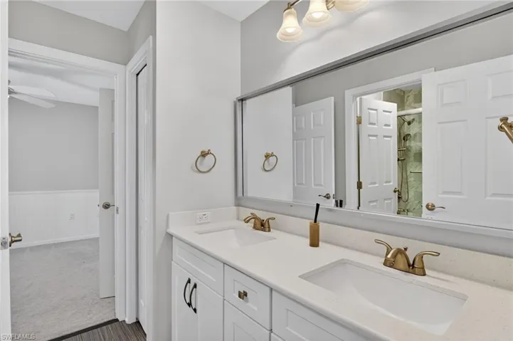 Double vanity with integrated sinks, quartz countertop, and brushed nickel hardware