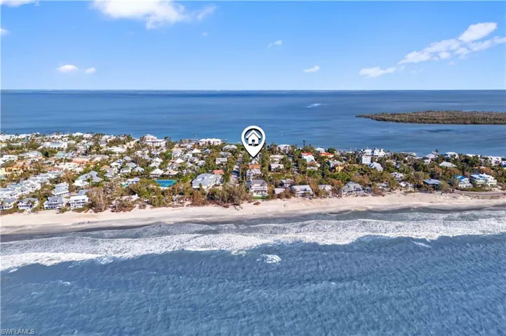 Drone / aerial view featuring a water view and a beach view