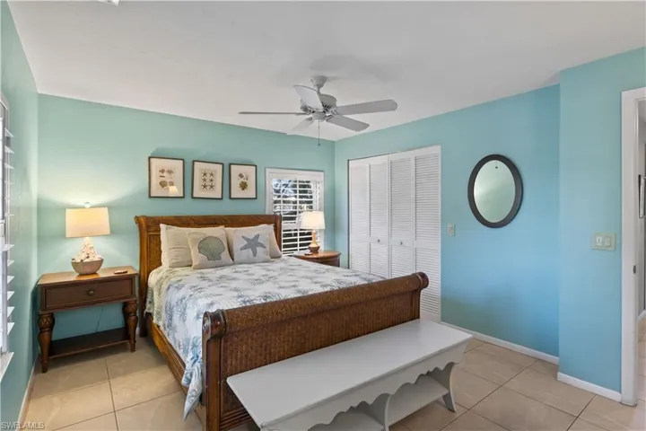 Bedroom featuring ceiling fan, a closet, and light tile patterned flooring