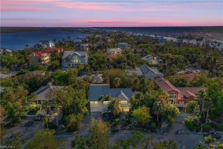 Aerial view at dusk featuring a water view