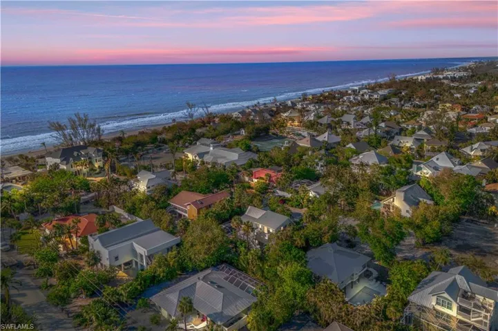 Aerial view at dusk with a view of the beach and a water view