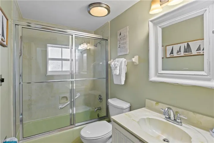 Full bathroom featuring combined bath / shower with glass door, and vanity
