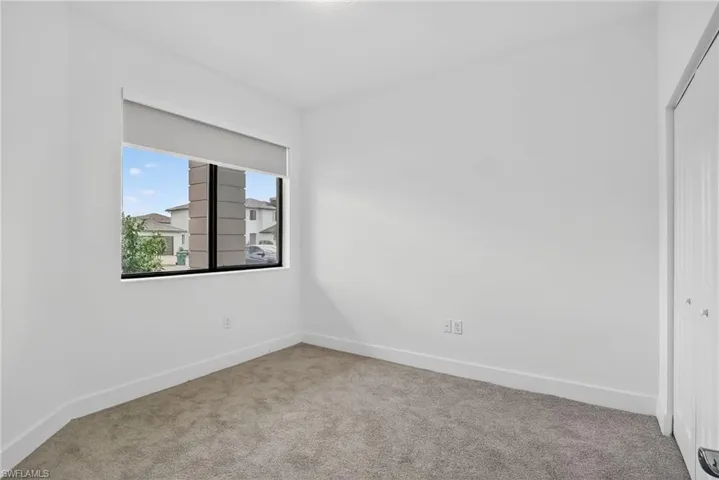 Unfurnished room with carpet floors and baseboards